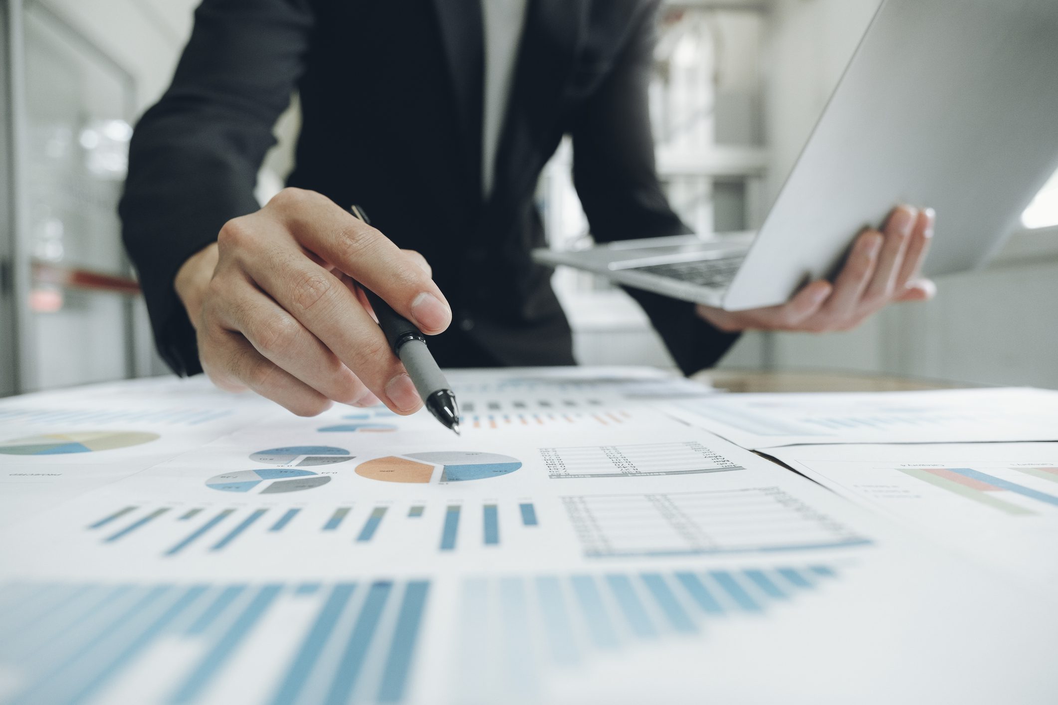 Analyzing financial charts with a laptop